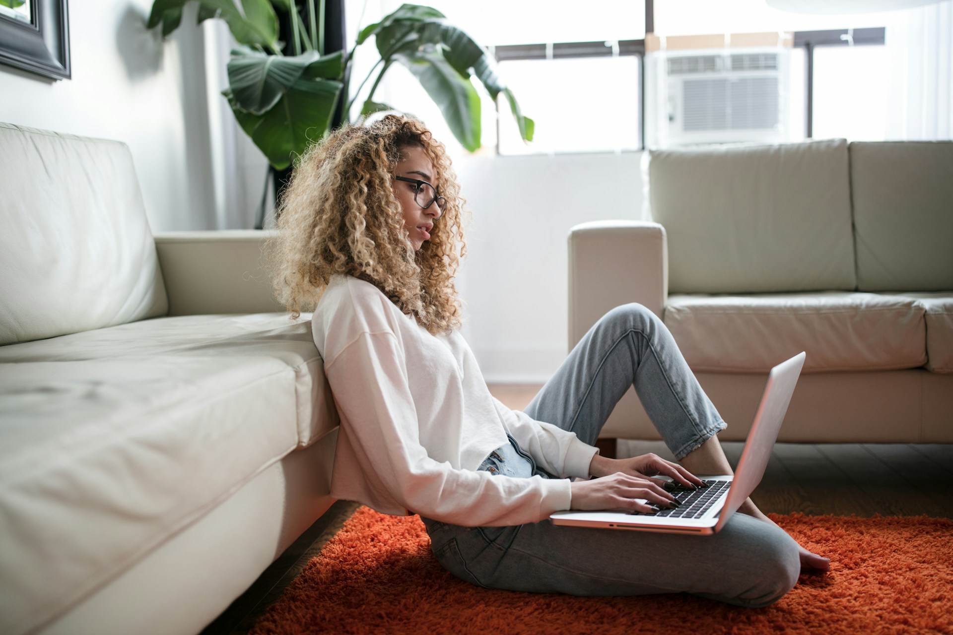 Woman entrepreneur reviewing website design cost estimates on a laptop