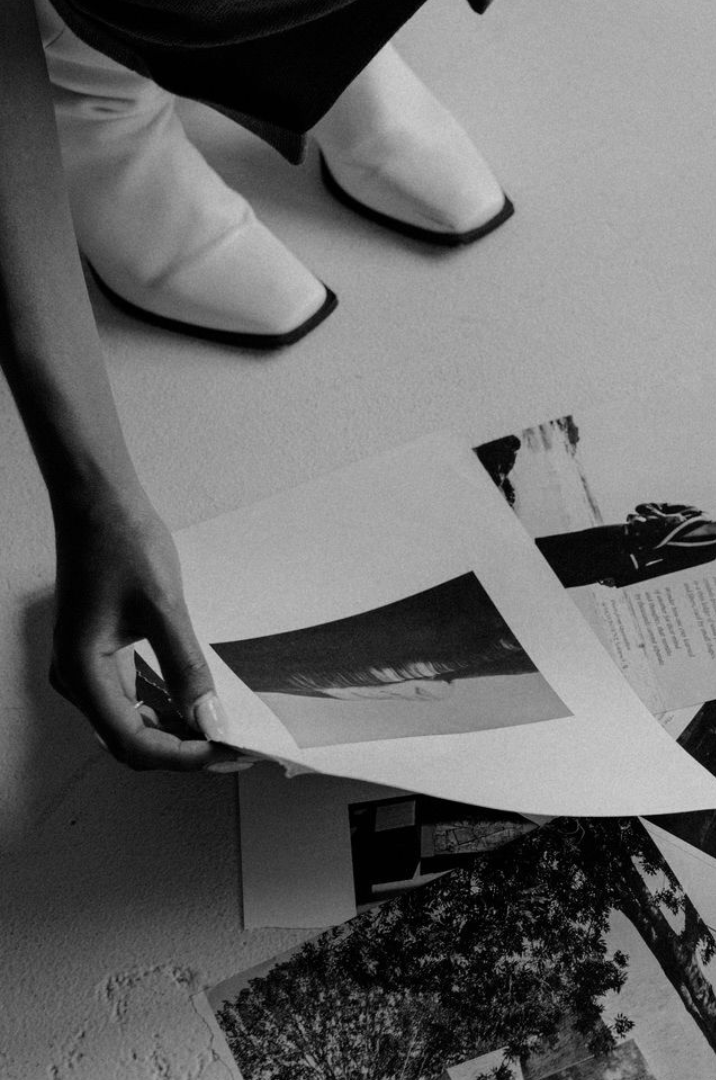 Woman picking photos on the floor for her Branding logo and her brand identity