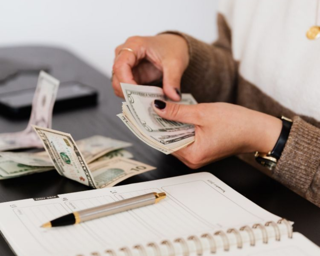 Woman budgeting and detailing the  breakdown for web design for small businesses cost.